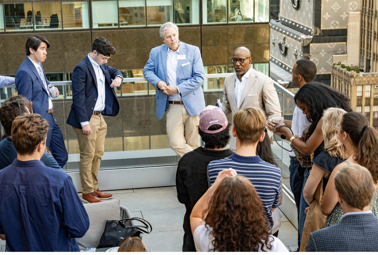 Bernard Bell leading a rooftop conversation with a group of professionals and students
